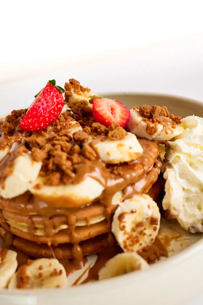 Nahaufnahme: Sauce tropft über fluffige Pancakes